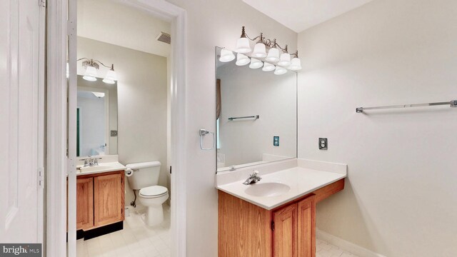 7265 Latham Ct, Hughesville, MD 20637 - bathroom featuring toilet, tile patterned flooring, two vanities, and baseboards