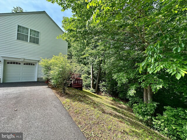 7265 Latham Ct, Hughesville, MD 20637 - view of side of home with an attached garage and driveway