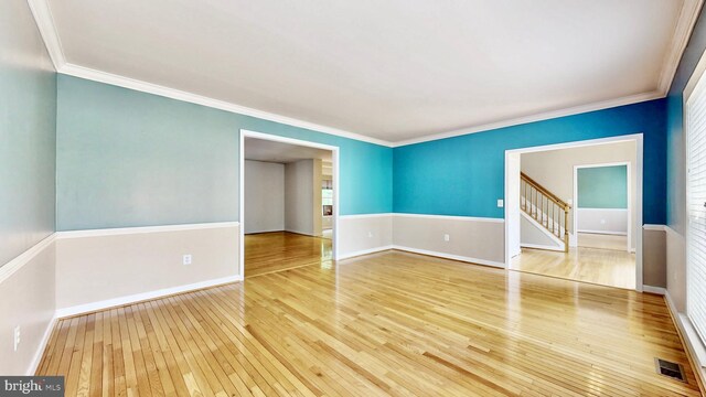7265 Latham Ct, Hughesville, MD 20637 - empty room featuring wood-type flooring, ornamental molding, baseboards, and stairway