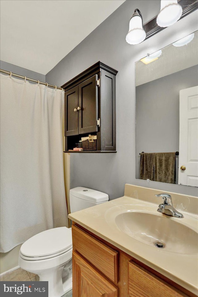 bathroom with toilet, vanity, tile patterned flooring, and curtained shower
