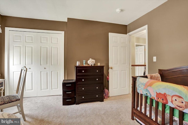 bedroom with light colored carpet and a closet