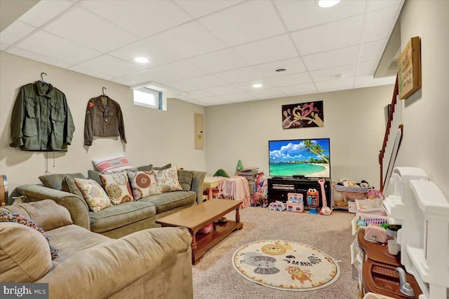 carpeted living area featuring a paneled ceiling, recessed lighting, and electric panel
