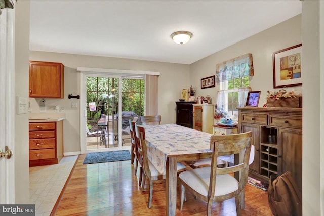 dining room featuring light wood-style floors and baseboards
