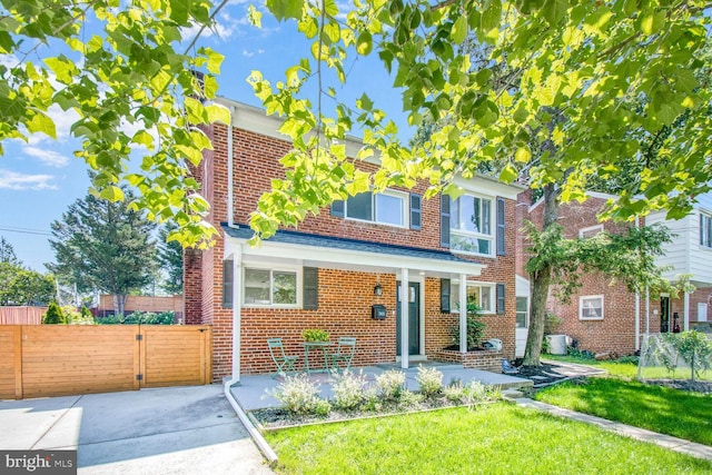 7603 Hammond Ave, Takoma Park, MD 20912 - view of front of property with brick siding, central air condition unit, and a gate