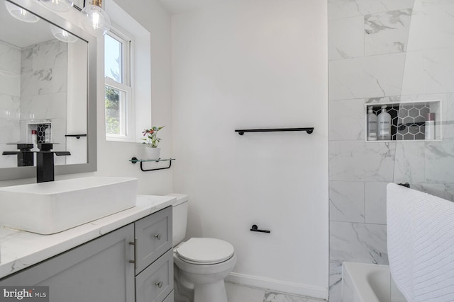 7603 Hammond Ave, Takoma Park, MD 20912 - bathroom with marble look tile flooring, vanity, toilet, and baseboards