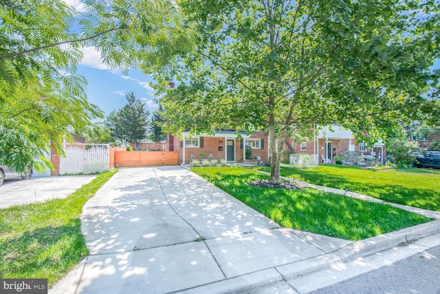7603 Hammond Ave, Takoma Park, MD 20912 - view of property hidden behind natural elements with brick siding, a gate, and driveway