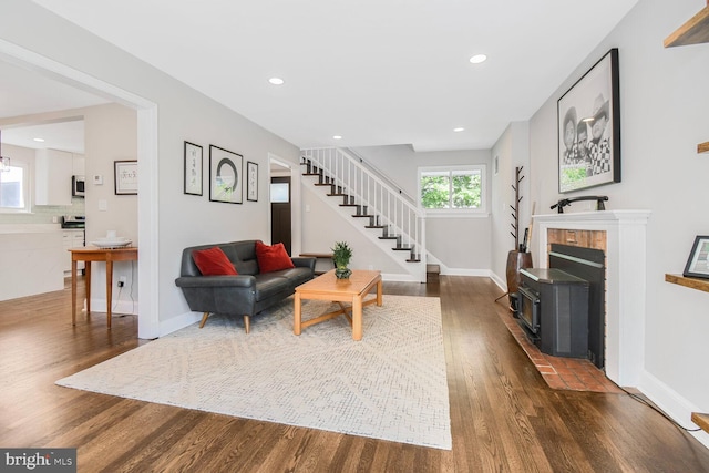 7603 Hammond Ave, Takoma Park, MD 20912 - living area with dark wood-style flooring, stairs, baseboards, recessed lighting, and a wood stove