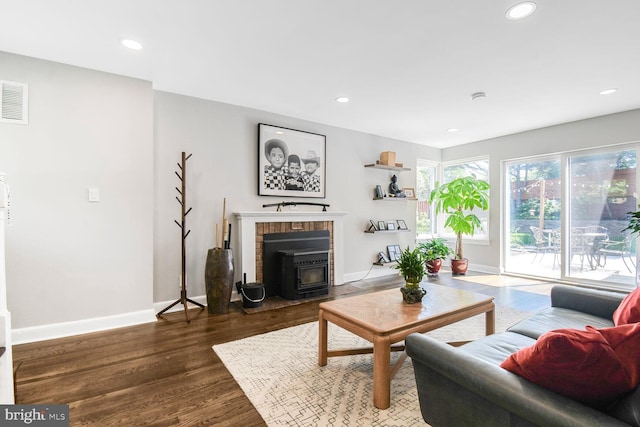 7603 Hammond Ave, Takoma Park, MD 20912 - living room with a wood stove, wood finished floors, baseboards, and recessed lighting