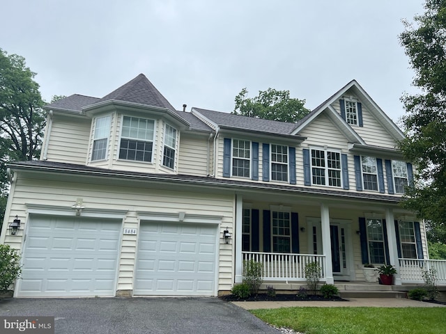 8484 Oak Run Way, Ellicott City, MD 21043 - view of front of property with covered porch, an attached garage, and driveway