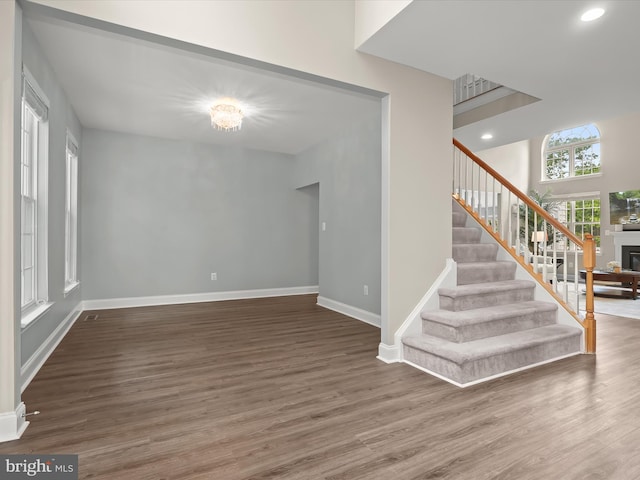 8484 Oak Run Way, Ellicott City, MD 21043 - unfurnished living room with wood finished floors, stairway, baseboards, recessed lighting, and a fireplace