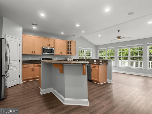 8484 Oak Run Way, Ellicott City, MD 21043 - kitchen featuring stainless steel appliances, a breakfast bar, dark wood-style flooring, a kitchen island, and a ceiling fan
