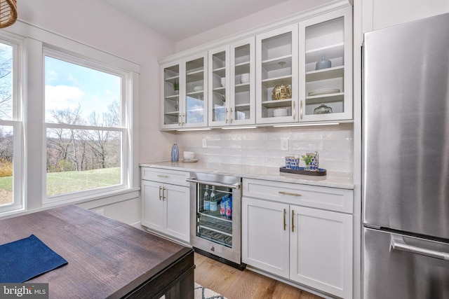 101 Eagle Dr, Broomall, PA 19008 - indoor dry bar featuring freestanding refrigerator, wine cooler, healthy amount of natural light, and decorative backsplash