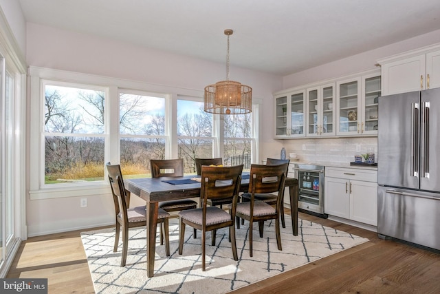 101 Eagle Dr, Broomall, PA 19008 - dining area featuring wine cooler, a chandelier, healthy amount of natural light, and light wood finished floors