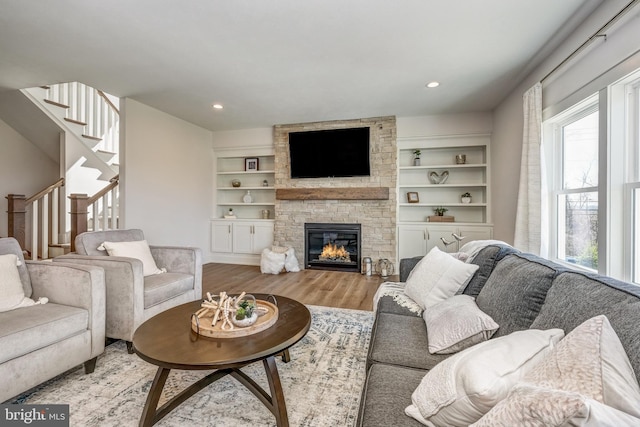 101 Eagle Dr, Broomall, PA 19008 - living area with wood finished floors, a stone fireplace, stairs, recessed lighting, and built in features