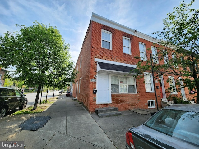 view of property with brick siding and entry steps