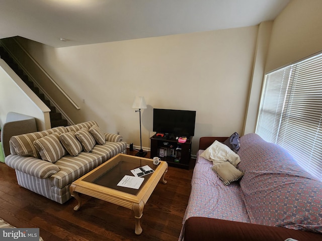 living room with dark wood finished floors and stairs