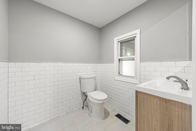 97 Church St, Thorofare, NJ 08086 - bathroom featuring tile walls, wainscoting, toilet, vanity, and tile patterned flooring