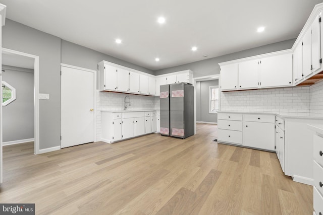 97 Church St, Thorofare, NJ 08086 - kitchen with freestanding refrigerator, light countertops, backsplash, white cabinets, and recessed lighting