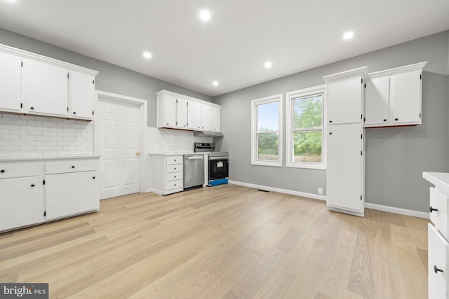 97 Church St, Thorofare, NJ 08086 - kitchen with stainless steel appliances, light countertops, backsplash, white cabinetry, and light wood-type flooring
