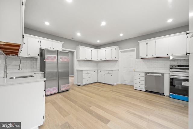 97 Church St, Thorofare, NJ 08086 - kitchen featuring appliances with stainless steel finishes, a sink, decorative backsplash, white cabinetry, and recessed lighting