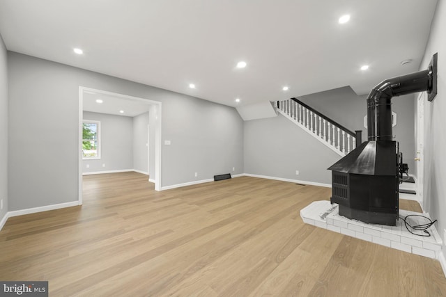 97 Church St, Thorofare, NJ 08086 - unfurnished living room with a wood stove, light wood-style floors, stairs, recessed lighting, and baseboards
