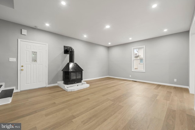 97 Church St, Thorofare, NJ 08086 - unfurnished living room featuring a wood stove, light wood-style floors, recessed lighting, and baseboards