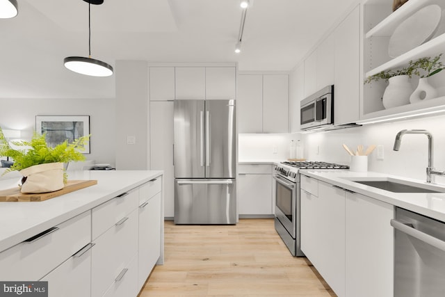 2939 Van Ness St NW Unit 424, Washington, DC 20008 - kitchen with appliances with stainless steel finishes, a sink, white cabinets, modern cabinets, and light countertops
