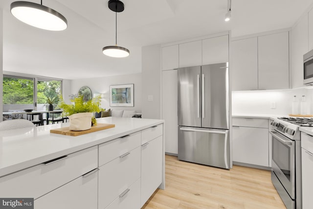2939 Van Ness St NW Unit 424, Washington, DC 20008 - kitchen with appliances with stainless steel finishes, white cabinetry, light countertops, and modern cabinets