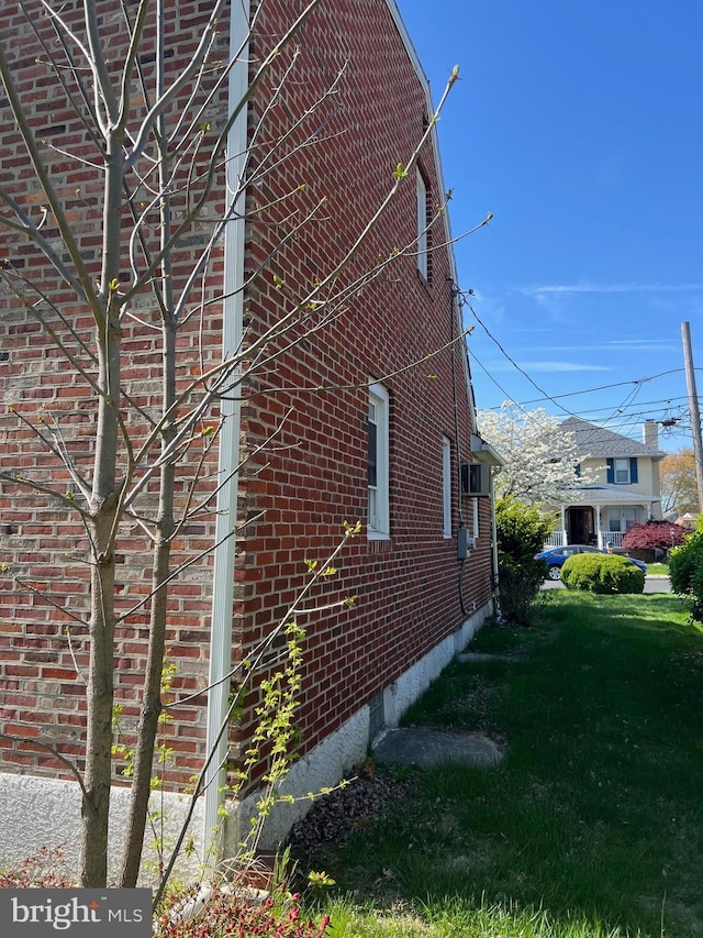 view of side of home with brick siding
