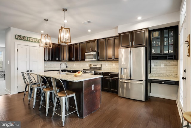 10117 Fosset St, Ijamsville, MD 21754 - kitchen with stainless steel appliances, a sink, a kitchen breakfast bar, tasteful backsplash, and dark wood-type flooring