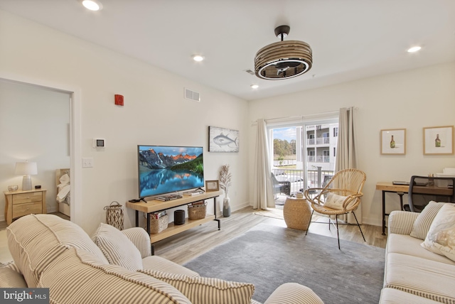 living area featuring wood finished floors, recessed lighting, and baseboards