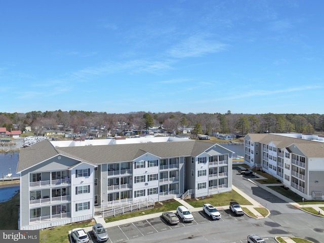aerial view of apartment complex and a nearby body of water
