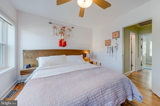 1702 Seaton St NW, Washington, DC 20009 - bedroom with multiple windows, wood finished floors, baseboards, and a ceiling fan