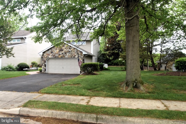 view of property hidden behind natural elements with stone siding, asphalt driveway, a garage, and a front lawn