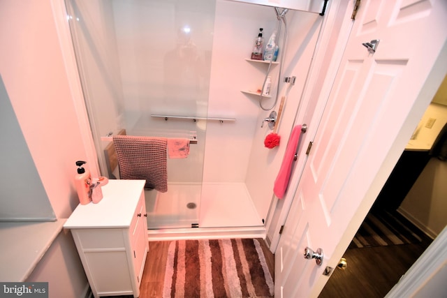 full bath with a shower stall and vanity