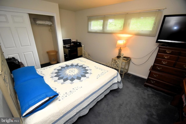 bedroom featuring a closet and dark carpet