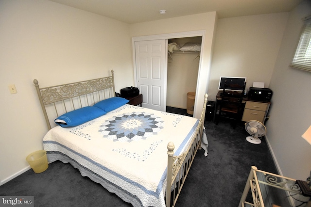bedroom featuring dark carpet, a closet, and baseboards