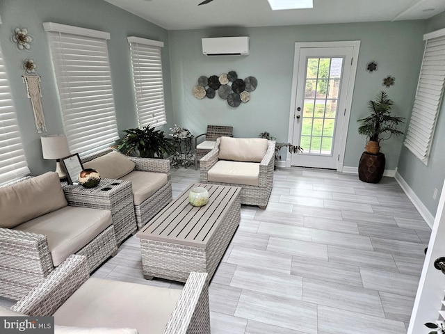 living room featuring an AC wall unit, baseboards, and a ceiling fan