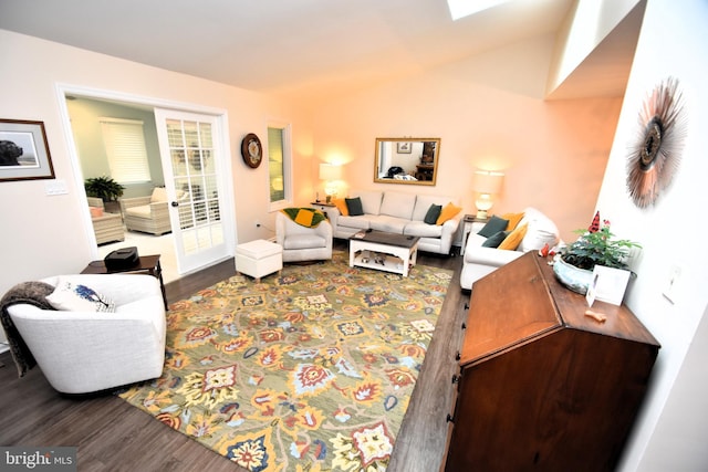 living area featuring wood finished floors and lofted ceiling