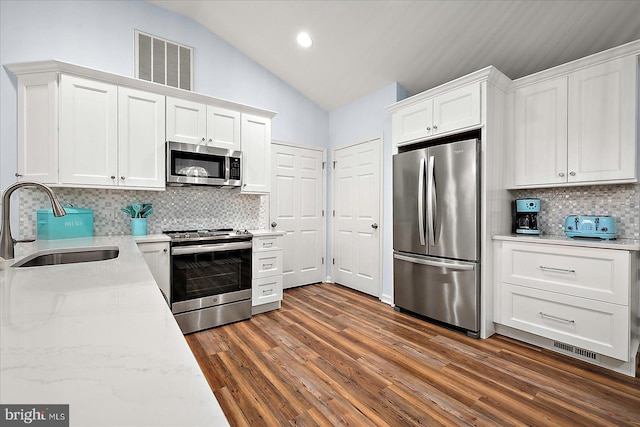 4 Abbey Cir, Ocean Pines, MD 21811 - kitchen featuring stainless steel appliances, a sink, lofted ceiling, white cabinetry, and tasteful backsplash
