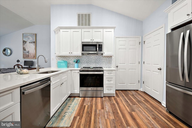4 Abbey Cir, Ocean Pines, MD 21811 - kitchen featuring stainless steel appliances, a sink, lofted ceiling, backsplash, and light countertops
