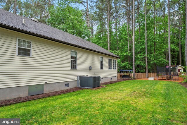 4 Abbey Cir, Ocean Pines, MD 21811 - back of house with a trampoline, crawl space, central AC, and a shingled roof