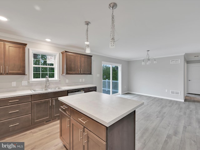864 Wynonah Dr, Auburn, PA 17922 - kitchen with a sink, ornamental molding, a chandelier, light wood finished floors, and light countertops