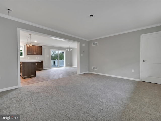 864 Wynonah Dr, Auburn, PA 17922 - unfurnished living room featuring light carpet, ornamental molding, baseboards, and a chandelier