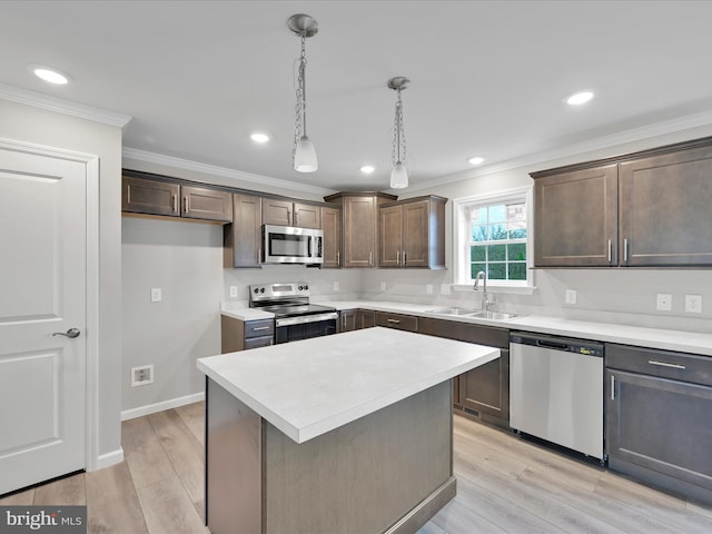 864 Wynonah Dr, Auburn, PA 17922 - kitchen featuring stainless steel appliances, a sink, crown molding, dark brown cabinets, and light countertops