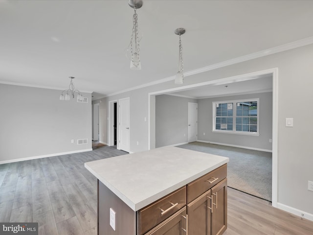 864 Wynonah Dr, Auburn, PA 17922 - kitchen with open floor plan, a chandelier, crown molding, baseboards, and light countertops