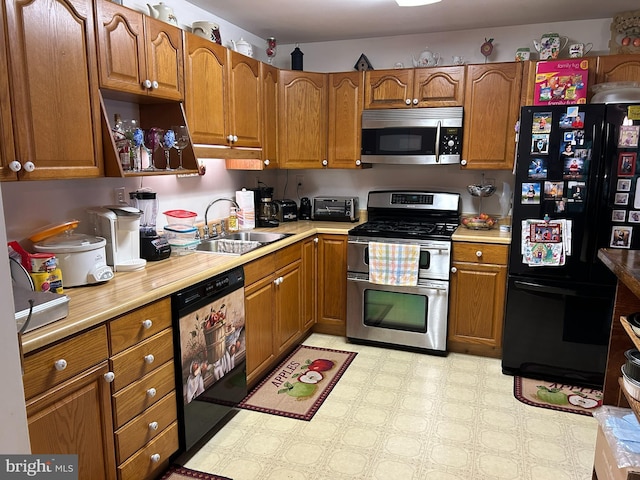 830 Western Ln, Front Royal, VA 22630 - kitchen with appliances with stainless steel finishes, a sink, brown cabinets, light countertops, and light flooring