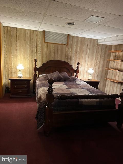 100 W Ave, Hanover, PA 17331 - bedroom with wood walls and dark carpet