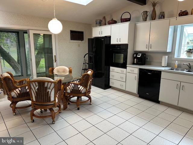 100 W Ave, Hanover, PA 17331 - kitchen with black appliances, a sink, light countertops, pendant lighting, and white cabinets