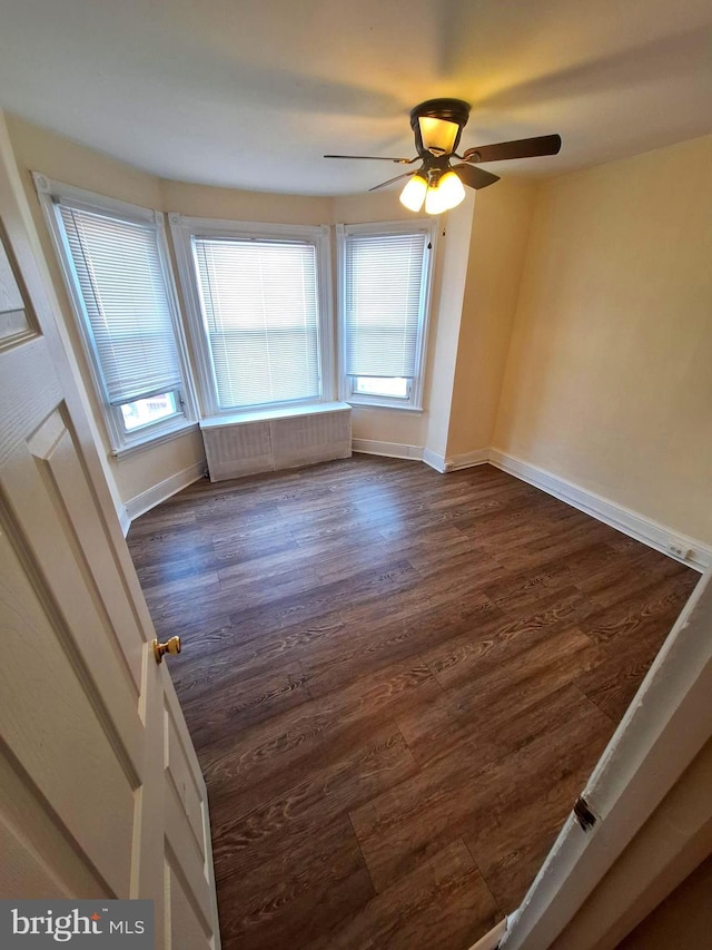 126 N Sickels St, Philadelphia, PA 19139 - spare room with a ceiling fan, dark wood-style flooring, and baseboards